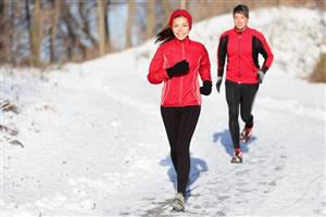Two people jogging in the snow